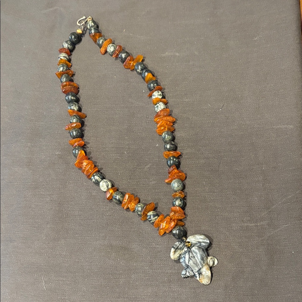 Carved frog pendant stone bead necklace.